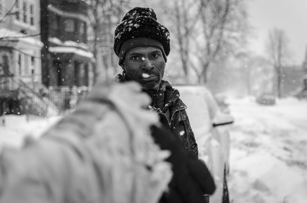 black and white photo of man in snowfall